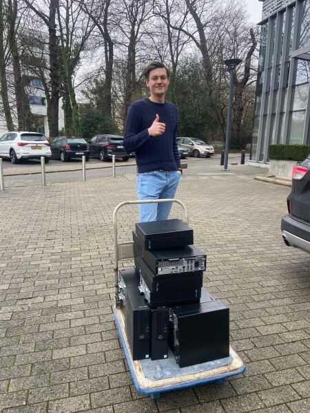 Someone with old computers on a parking lot